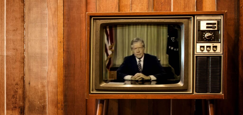 Image of an old TV with Jimmy Carter giving a presidential address on the screen