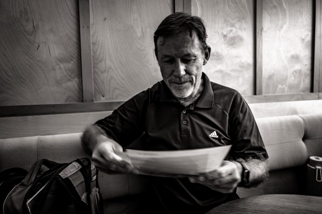 A photo of Simon Hertnon reviewing a document